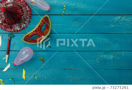 Table top view aerial image of beautiful colorful carnival festival background.Flat lay accessory object the several mask decor confetti on modern blue wooden at home office desk studio.copy space. Table top view aerial image of beautiful colorful carnival festival background.Flat lay accessory object the several mask decor confetti on modern blue wooden at home office desk studio.copy space. 73275261