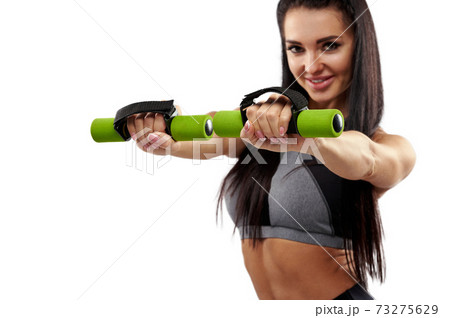 Focus on hands of an attractive young woman working out with dumbbells 73275629