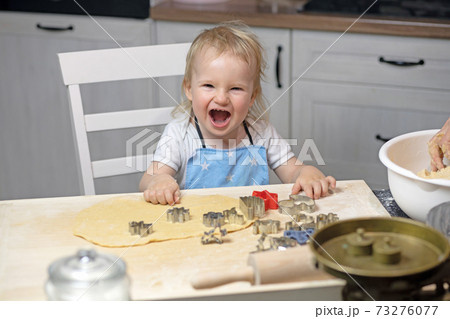 Laughing little boy prepare for baking cookies at home 73276077