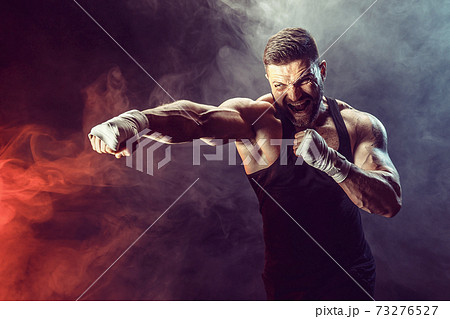 Sportsman boxer fighting on black background with shadow. Copy Space. Boxing sport concept. Sportsman boxer fighting on black background with shadow. Copy Space. Boxing sport concept. 73276527