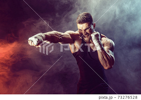 Sportsman boxer fighting on black background with shadow. Copy Space. Boxing sport concept. 73276528