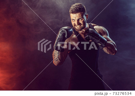 Sportsman boxer fighting on black background with shadow. Copy Space. Boxing sport concept. 73276534