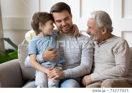 Smiling three generations of men relax at home 73277925