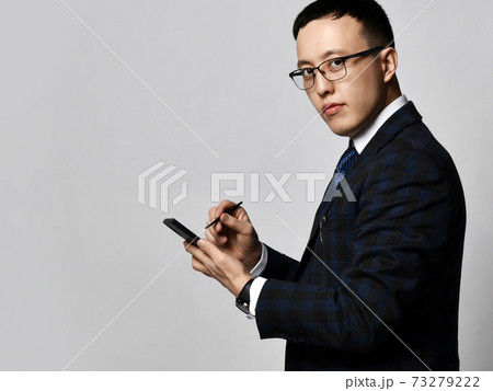 Young confident asian businessman in checkered Young confident asian businessman in checkered 73279222