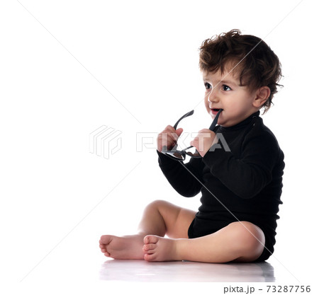 Baby holding glasses taking first step portrait 73287756