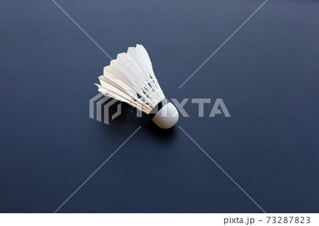 Shuttlecock or badminton ball on dark background. Shuttlecock or badminton ball on dark background. 73287823