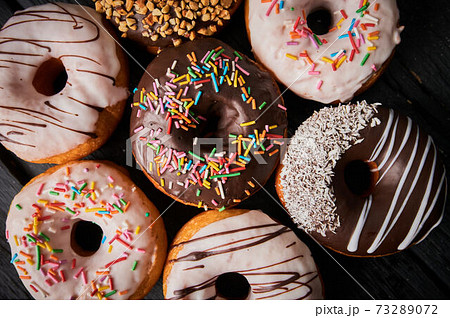 Colorful donuts on stone table. Top view with copy space. 73289072
