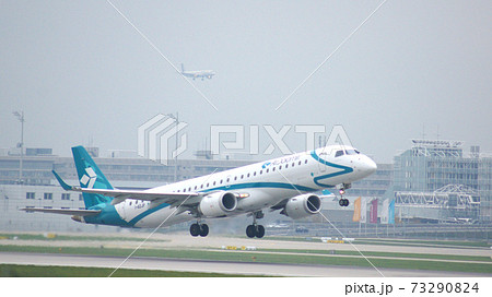 MUNICH, GERMANY - 11 OCTOBER 2015: Jet plane Embraer E-Jet ERJ-195 of Air Dolomiti Italian airlines take off from Munich international passenger airport and gains altitude 73290824
