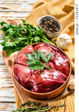 Raw fresh duck liver in a bowl. White background. Top view 73291977