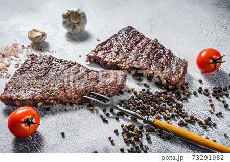 Grilled rump steak with spices. BBQ beef. Gray background. Top view 73291982