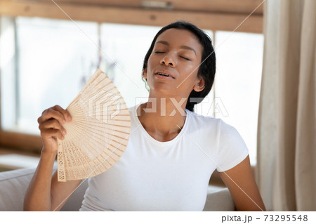 Happy millennial mixed race biracial lady feeling refreshed. 73295548