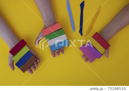 Preschoolers with colorful clay. Toddler playing and creating toys from play dough. Preschoolers with colorful clay. Toddler playing and creating toys from play dough. 73298510