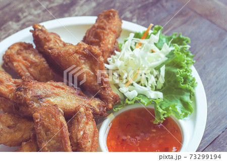 Fried Chicken with Thai Herb serve with spicy sauce. Travel cuisine in Thailand can eat on street food. Fried Chicken with Thai Herb serve with spicy sauce. Travel cuisine in Thailand can eat on street food. 73299194
