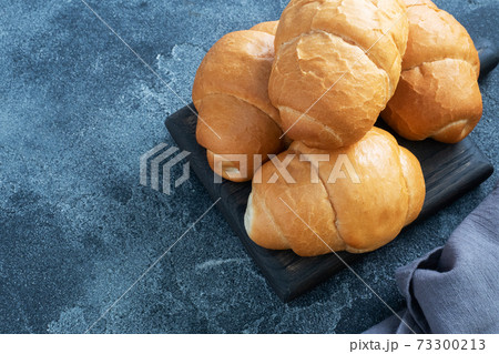 Fresh wheat bread rolls. Rolls for a hot dog or hamburger. Dark background copy space. 73300213