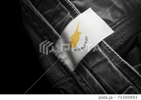 Tag on dark clothing in the form of the flag of the Cyprus Tag on dark clothing in the form of the flag of the Cyprus 73300993