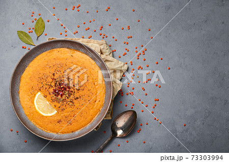 Ezogelin Soup in gray bowl on concrete table top. Turkish cuisine traditional dish Ezogelin Soup in gray bowl on concrete table top. Turkish cuisine traditional dish 73303994