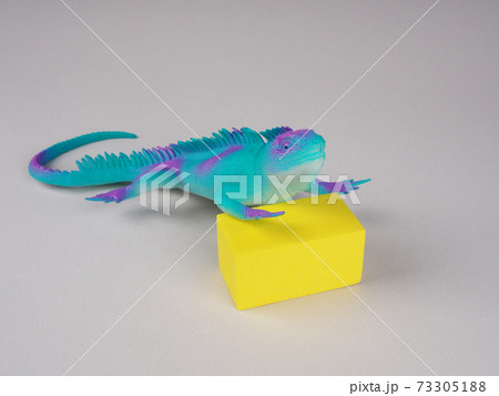 toy iguana lizard on a gray and yellow background, concept photo, space for text toy iguana lizard on a gray and yellow background, concept photo, space for text 73305188