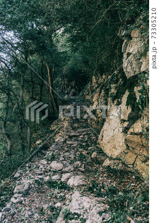 mountains of sadernes on a cloudy summer day in spain 73305210