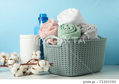Laundry accessories on white table against blue background Laundry accessories on white table against blue background 73305394