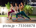 Asian weman group do yoga in city at night 73308878