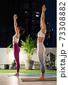 Asian women do yoga in city at night 73308882