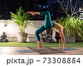 Asian woman do yoga in city at night 73308884