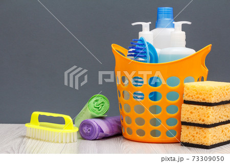 Bottles of dishwashing liquid, brush in a basket and sponges, brush, garbage bags. 73309050