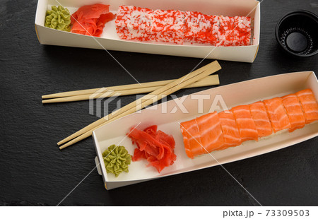 california sushi with red tobiko caviar and slices of philadelphia sushi with eel in a white box california sushi with red tobiko caviar and slices of philadelphia sushi with eel in a white box 73309503