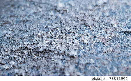 White hoarfrost crystals on flat surface closeup view White hoarfrost crystals on flat surface closeup view 73311902