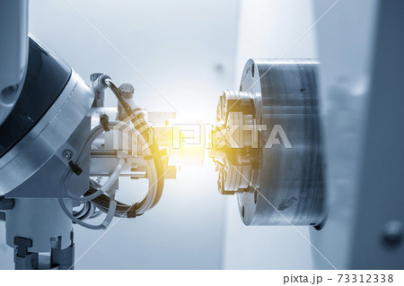 The robotics arm gripping the metal part. 73312338