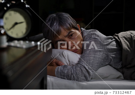 Depressed senior woman lying in bed cannot sleep from insomnia Depressed senior woman lying in bed cannot sleep from insomnia 73312467