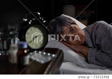 Depressed senior woman lying in bed cannot sleep from insomnia Depressed senior woman lying in bed cannot sleep from insomnia 73312468