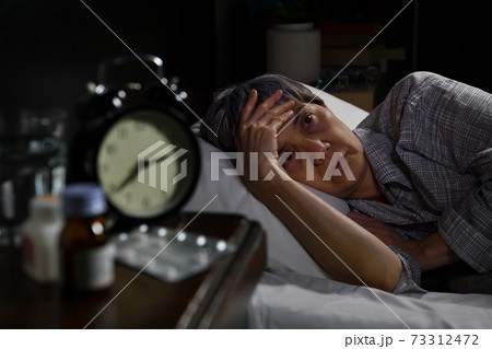 Depressed senior woman lying in bed cannot sleep from insomnia Depressed senior woman lying in bed cannot sleep from insomnia 73312472