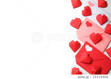 Red, pink, white paper envelopes with colored hearts, 3D handmade paper hearts on white background. Love, Valentine's, mother's, women's day, relations, wedding, romantic template copy space 73314400