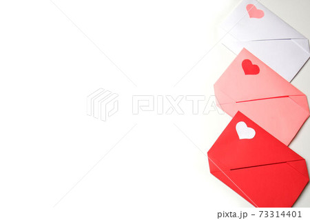 Red, pink, white paper envelopes with colored hearts on white background copy space. Love, Valentine's, mother's, women's day, relations, wedding, romantic concept Red, pink, white paper envelopes with colored hearts on white background copy space. Love, Valentine's, mother's, women's day, relations, wedding, romantic concept 73314401
