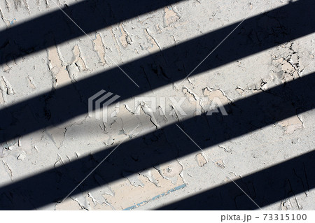 White painted surface with black stripes from the shade.  73315100