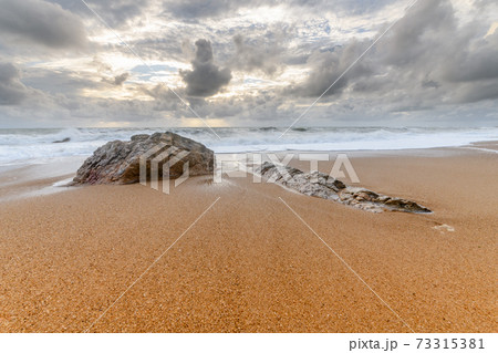 Rocks on a sandy beach in the Atlantic Ocean Rocks on a sandy beach in the Atlantic Ocean 73315381