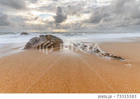 Rocks on a sandy beach in the Atlantic Ocean Rocks on a sandy beach in the Atlantic Ocean 73315383