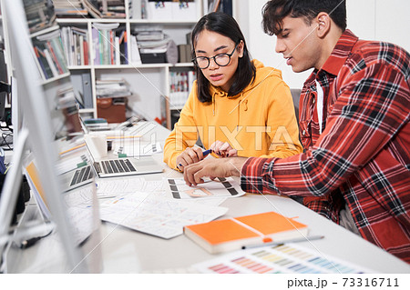Designers discussing with each other difficult work tasks 73316711