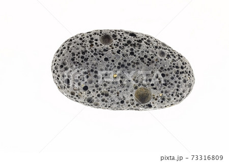 Smoke whirling around small meteorite stone 73316809