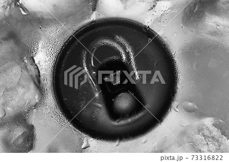 Aluminium tin can in fridge with ice closeup photo 73316822