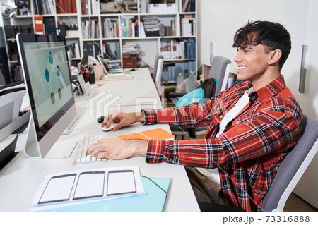 Designer sitting in front of the imac computer Designer sitting in front of the imac computer 73316888