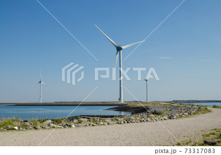 Oosterscheldekering, the netherlands, August 2019. In the Zeeland countryside, wind farms Oosterscheldekering, the netherlands, August 2019. In the Zeeland countryside, wind farms 73317083
