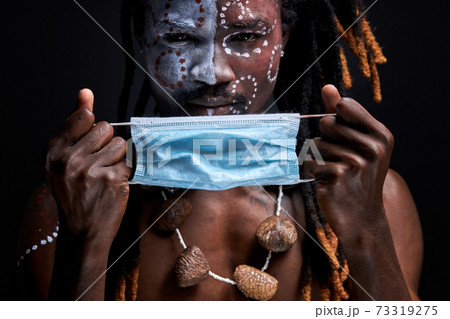 portrait of african aborigen male wearing medical mask on face portrait of african aborigen male wearing medical mask on face 73319275