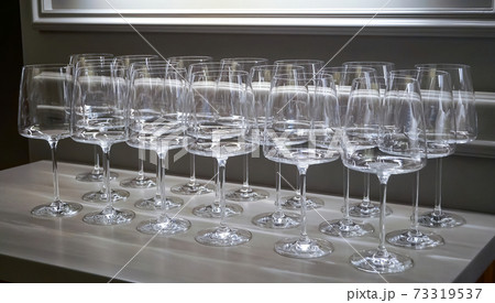 Empty clean wine, water, juice glasses in a kitchen of a restaurant or cafe. Catering buffet in restaurant room. Concept preparing for celebration Empty clean wine, water, juice glasses in a kitchen of a restaurant or cafe. Catering buffet in restaurant room. Concept preparing for celebration 73319537