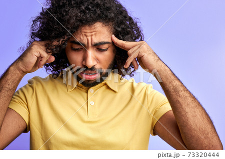 young curly man is trying to remember young curly man is trying to remember 73320444