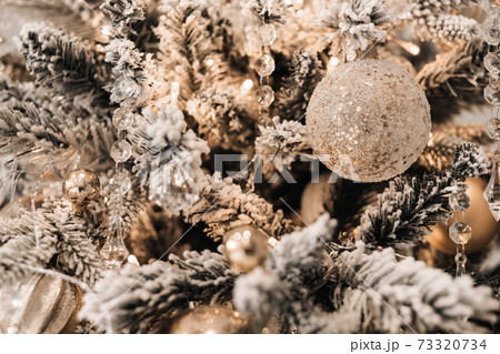 Christmas tree close-up. On New year's eve, a decorated snow-covered Christmas tree. Christmas tree close-up. On New year's eve, a decorated snow-covered Christmas tree. 73320734