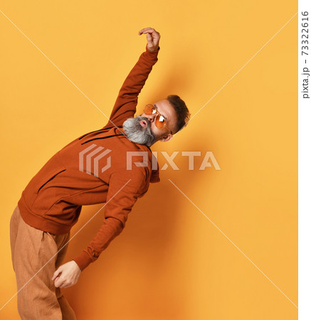 Strong bearded man bending backwards studio shot 73322616