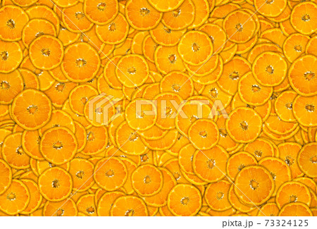 Mandarine Citrus reticulata background covered with slices. 73324125