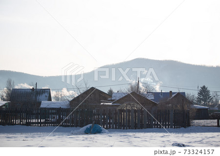 Snowy winter in russian village. Siberia, frost 73324157